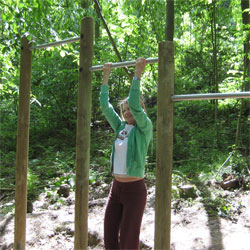 Woman using an outdoor fitness/trim trail