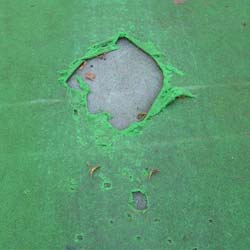 Damage caused by spikes, exposing the cricket base pad.